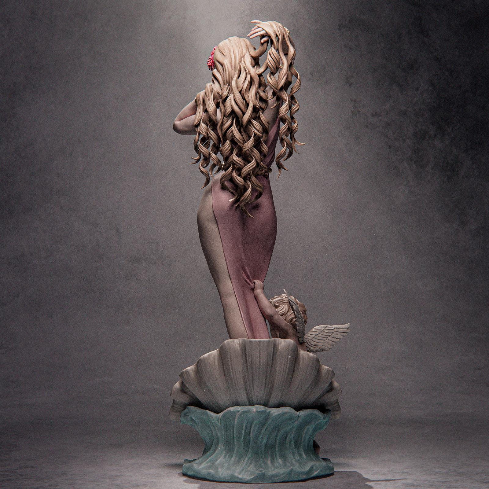 a statue of a woman sitting on top of a shell