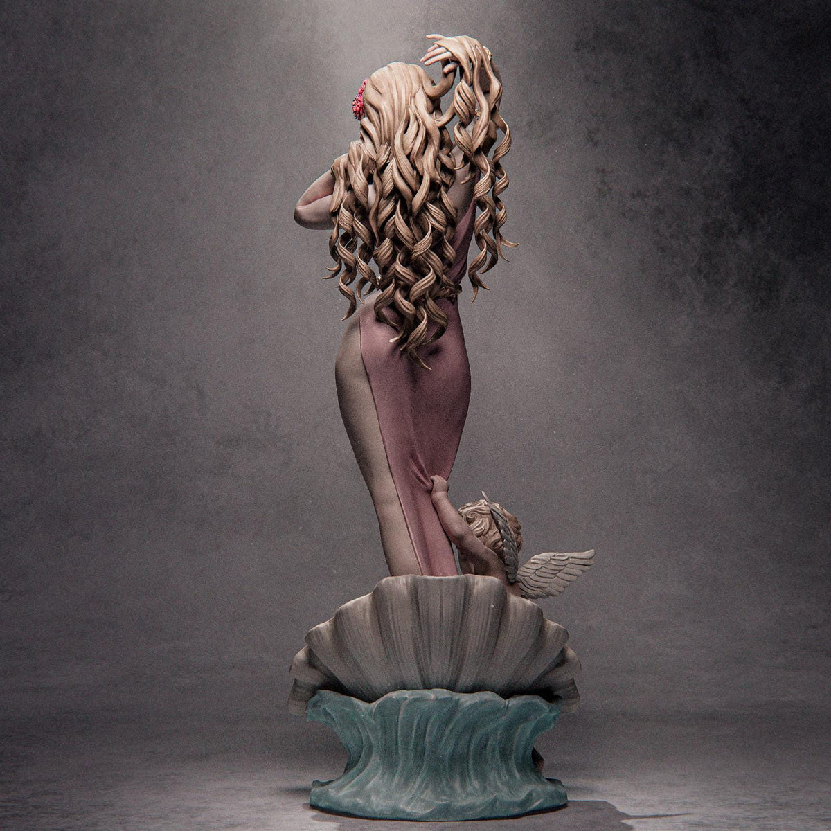 a statue of a woman sitting on top of a shell