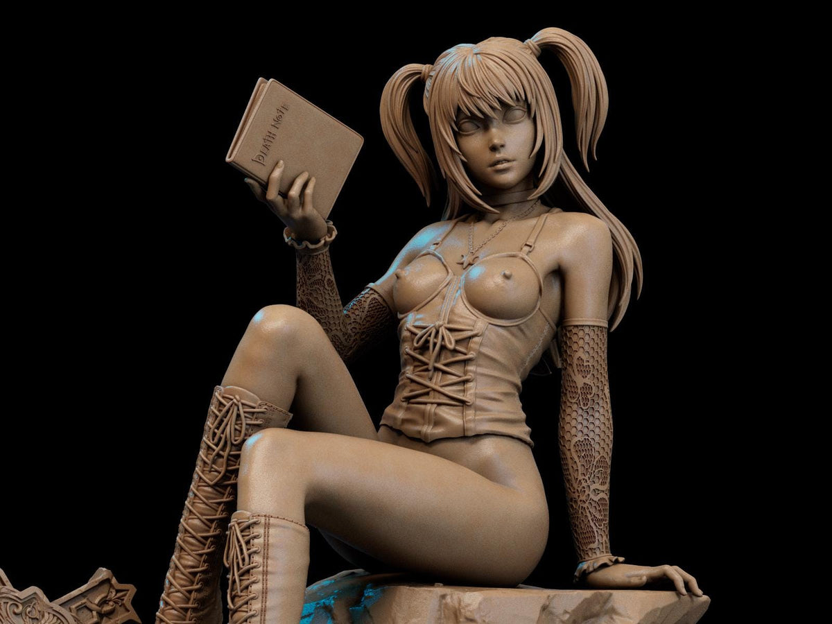 a statue of a woman sitting on a rock holding a book