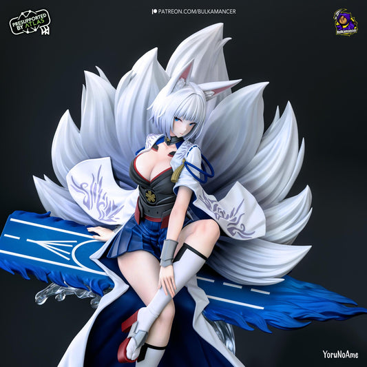 a woman with white hair sitting on top of a blue and white object