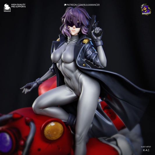 a statue of a woman dressed as a super hero sitting on top of a red